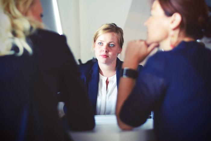 A photo showing three people in a business setting